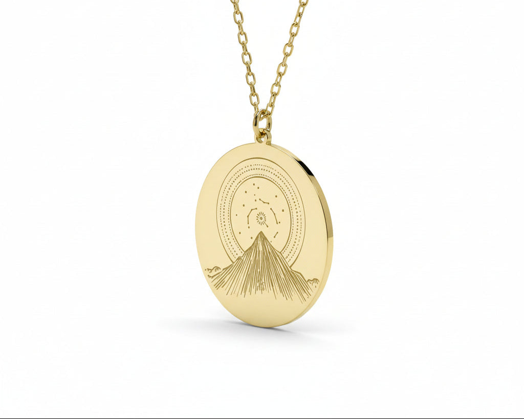 Gold necklace with a round pendant on a white background